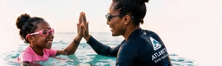 Illustrative instructor and swimmer celebrating progress with a high-five